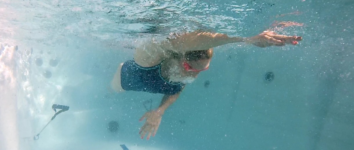 woman swimming in a swim spa