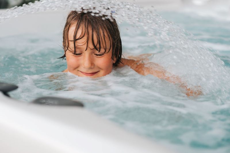 little boy in hot tub